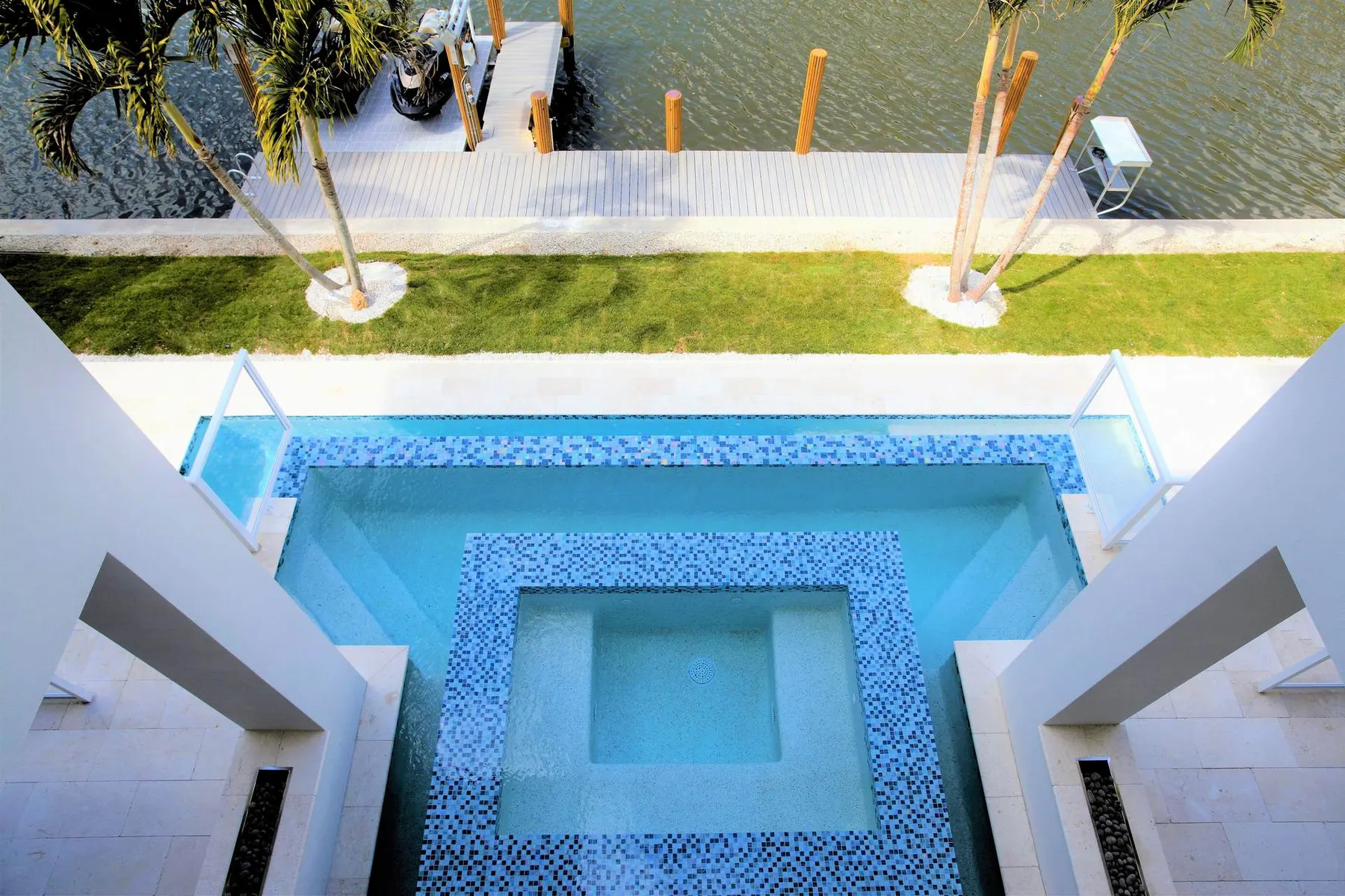 Aerial view of the elevated pool and spa beside the canal.