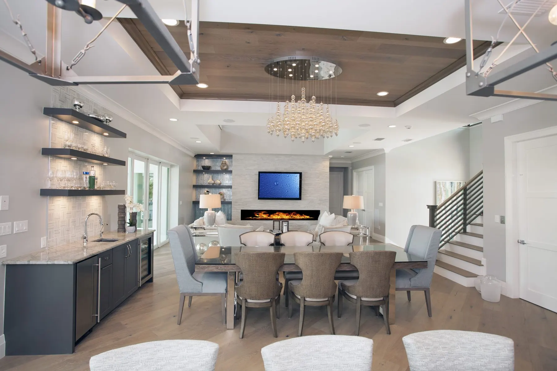 Dining area and bar beneath a wood-lined tray ceiling.
