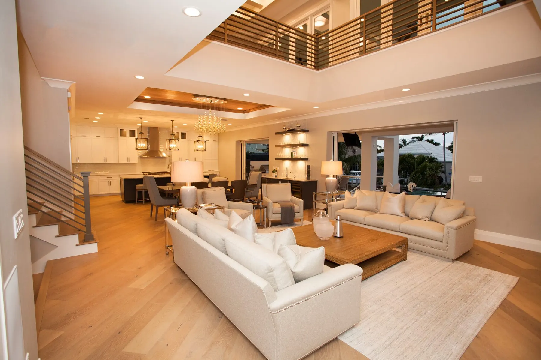 Open living area with a double-height void and wood floors.
