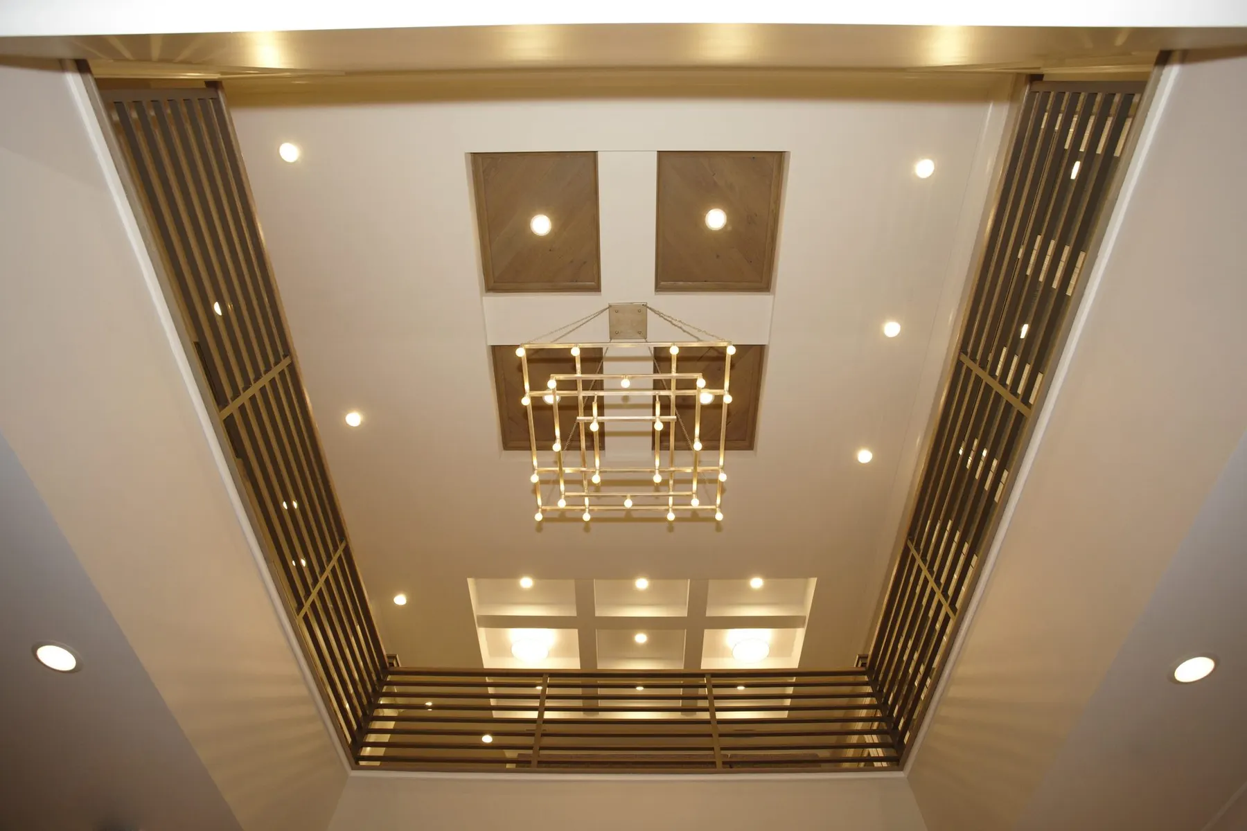 Ceiling detail with wood panels and slatted metal accents.