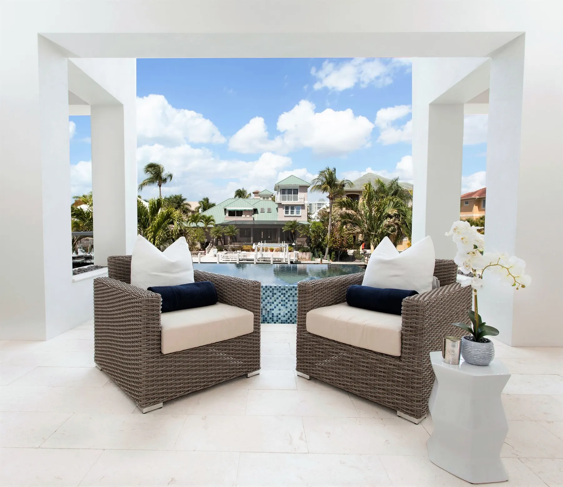 Covered terrace seating framing a view across the water.