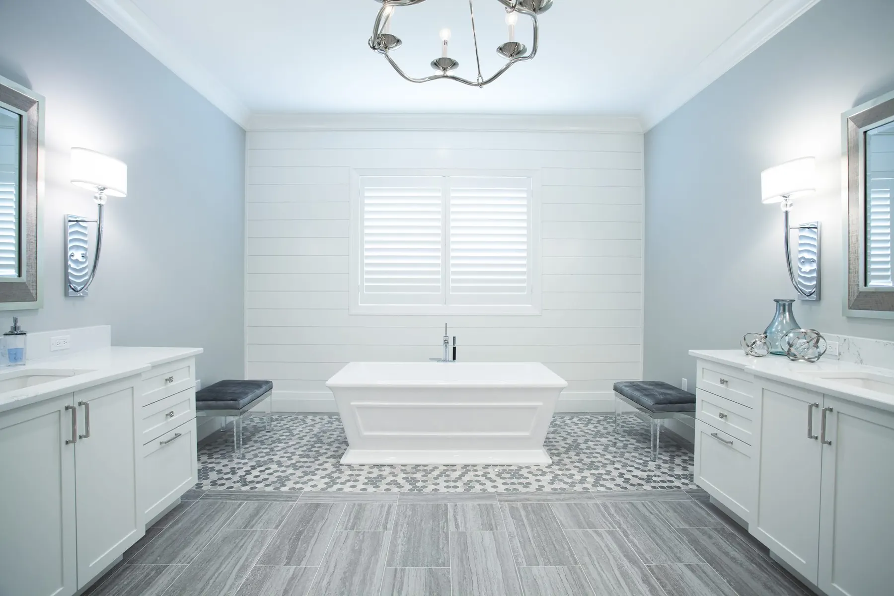 Bathroom with a freestanding tub and a paneled wall.