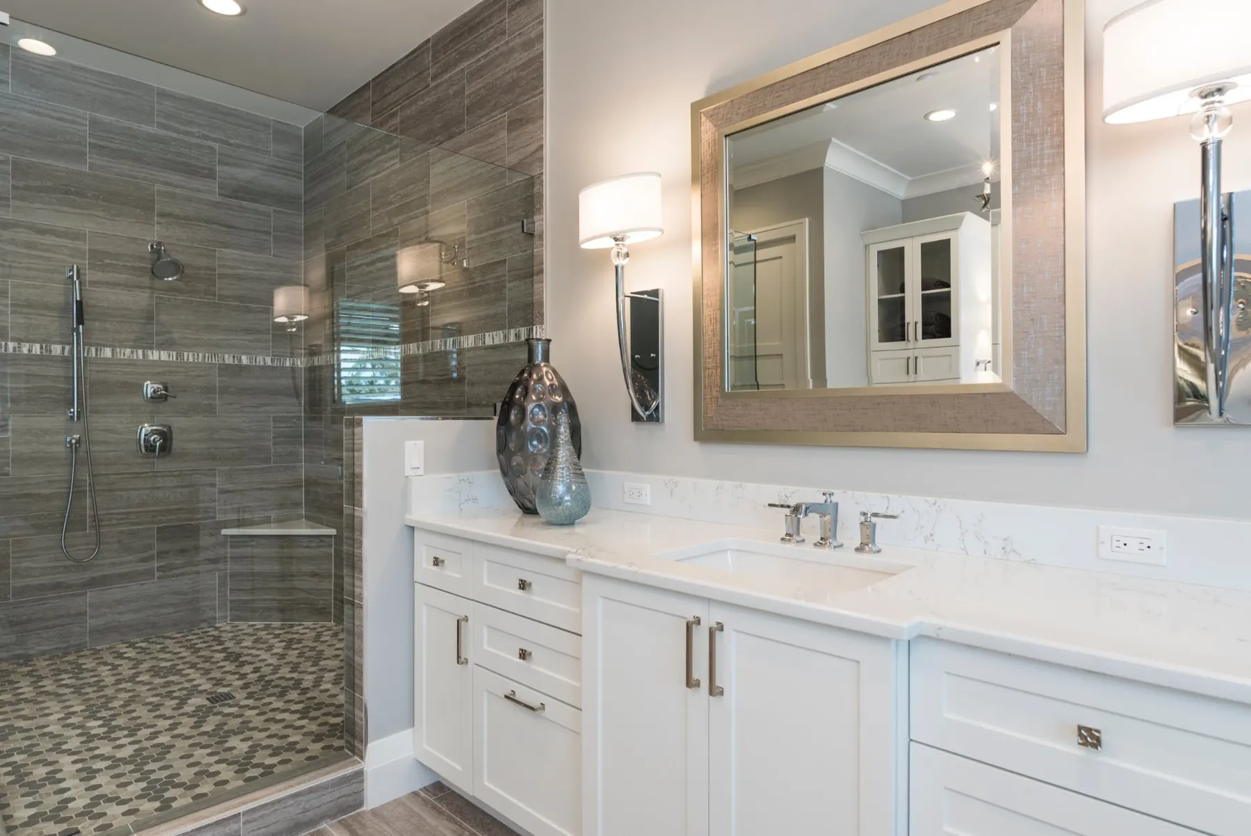 Bathroom with a walk-in glass shower, wood-look tile walls and a white vanity.