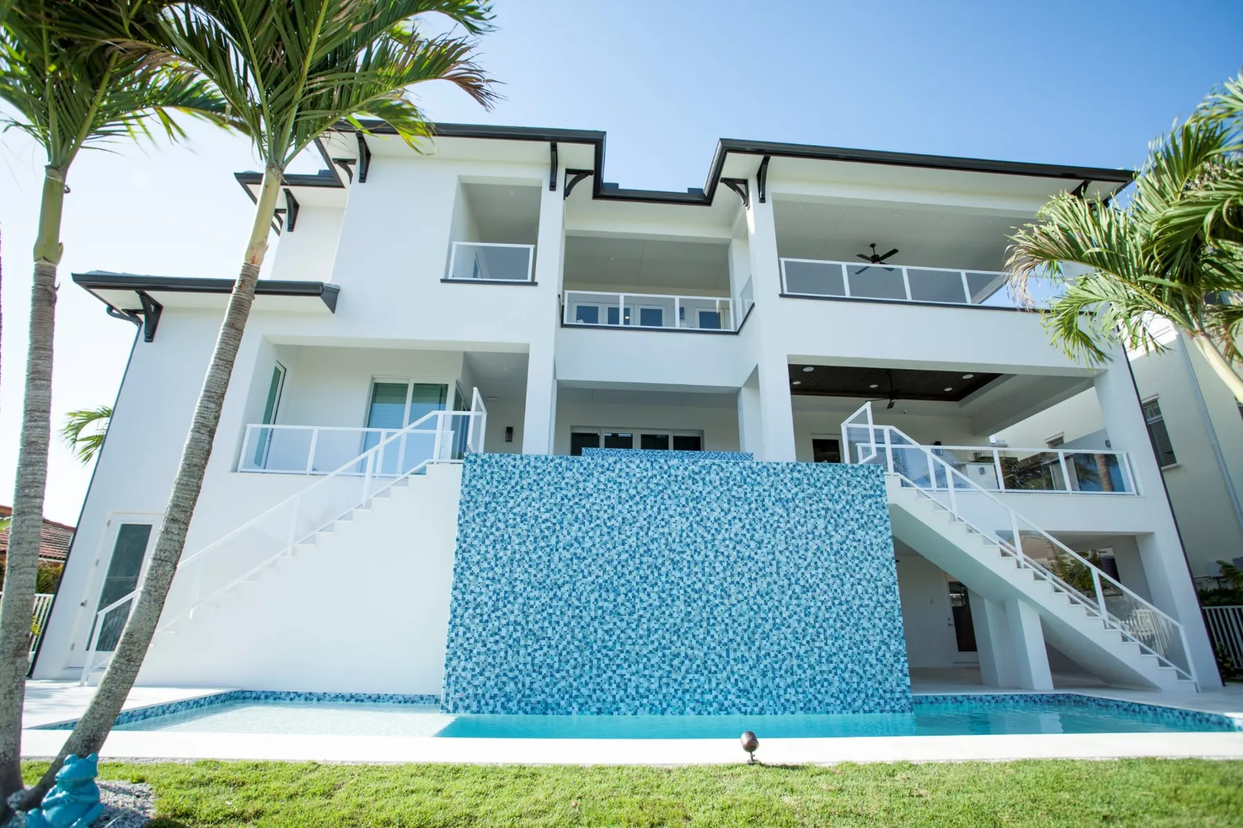 Rear elevation with the glass-tile water feature wall above the pool.