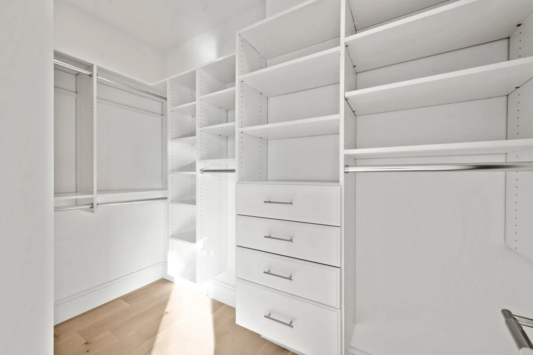 Closet with built-in drawers and shelves.